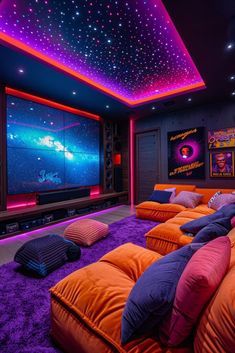 an orange couch sitting in front of a large screen on top of a purple carpet