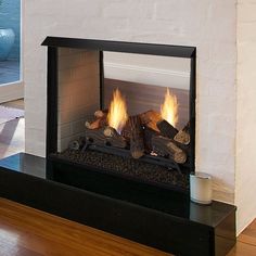 a fireplace with logs burning inside of it