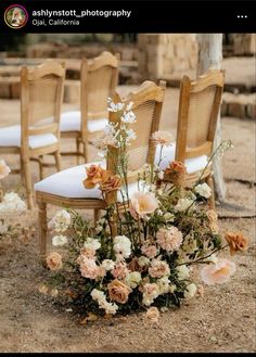 an arrangement of flowers and chairs for a wedding