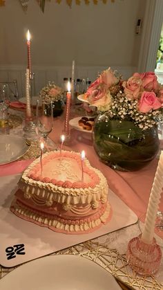 a table with a cake and candles on it