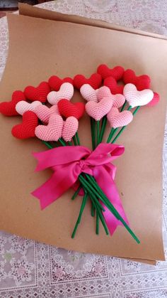 valentine's day card with crocheted hearts and pink ribbon tied to it