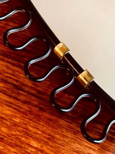 a close up of a metal object on a wooden surface