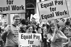 a group of people holding up signs in the street with words equal pay for equal work