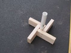 a piece of wood that has been placed on the ground with two sticks sticking out of it