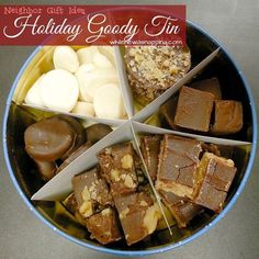 a holiday goody tin is filled with chocolate, nuts and candy bars as well as marshmallows