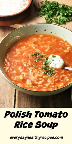 a bowl of tomato and rice soup on a wooden table with the words polish tomato rice soup