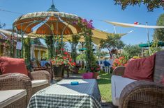 an outdoor area with wicker furniture and flowers