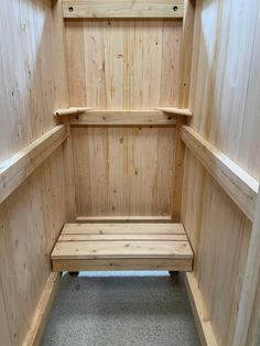 a wooden bench sitting in the corner of a room