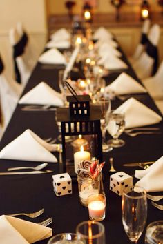 a long table is set with candles and napkins