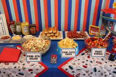 a table topped with lots of food and snacks