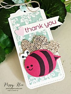 a thank you card with a bee on it and a green plant in the background