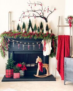 a fireplace decorated for christmas with stockings and garland on the mantel above it is a rocking horse