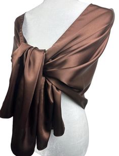 a mannequin torso wearing a brown wrap around it's neck and shoulders