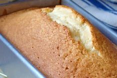 a loaf of bread sitting in a pan on top of a blue and white towel