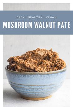 a blue bowl filled with mushroom walnut pate on top of a white countertop