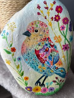 a painted rock with a bird on it