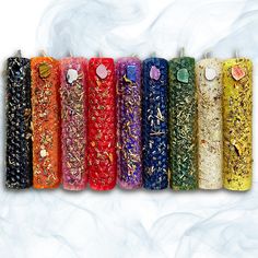 seven different colored incense sticks lined up in a row