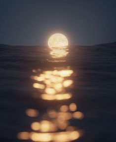 the moon is shining brightly over the water and reflecting light on it's surface