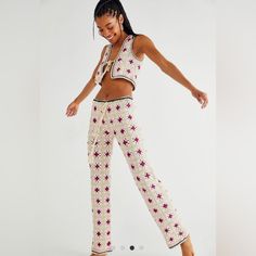 a woman in white and pink patterned pants dancing