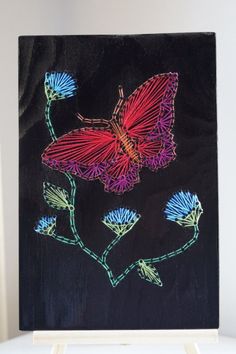 a painting of two butterflies on a black background