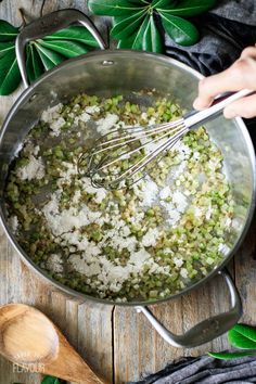 someone mixing rice and peas in a pot