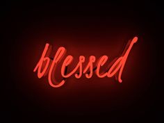 a red neon sign that says,'blessed'in the middle of it on a black background