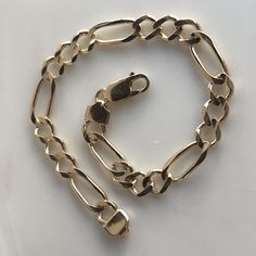 This is a beautiful Figaro Style Unisex bracelet. It has a nice weight to it. It is a great everyday bracelet that you will put on and never take off. Could be a great Father's Day gift. Crafted in 14k yellow gold. length is 8 inches Weight: 10.22grams Style: Figaro Chain Closure: Lobster clasp With any pre-owned/Vintage/Antique items, it is common to have some wear, As we inspect each piece of our jewelry, we make sure the wear and tear is acceptable within industry standards FOLLOW US TO SEE M Gold Figaro Chain Bracelet, Gold Bracelet With Figaro Chain, Classic 14k Gold Bracelets With Lobster Clasp, Elegant Gold Hallmarked Cuban Link Bracelet, Gold Link Bracelet Hallmarked, Formal Gold Plated Figaro Chain Bracelets, Luxury 14k Gold Bracelet With Figaro Chain, Classic 14k Gold Figaro Chain Bracelet, Formal Yellow Gold Figaro Chain Bracelet