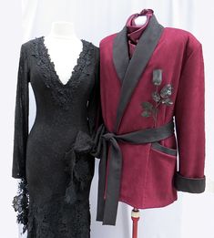 two mannequins dressed up in black and red outfits, one wearing a coat