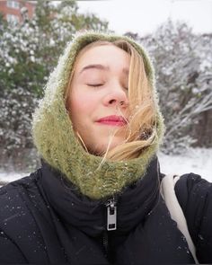 a woman with her eyes closed in the snow