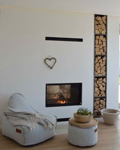 a living room filled with furniture and a fire place next to a wall mounted fireplace