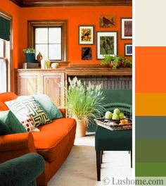 an orange living room with green accents and pictures on the wall, along with a fireplace