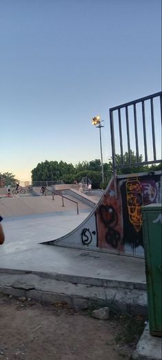 a man riding a skateboard up the side of a ramp at a skate park