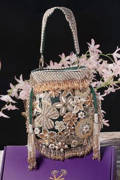 Green velvet potli with floral, beads, crystal, dabka and swarovski hand embroidery. Comes with a detachable handle. - Aza Fashions Luxury Embroidered Handheld Shoulder Bag, Embellished Rectangular Shoulder Bag For Receptions, Embellished Rectangular Shoulder Bag For Reception, Designer Party Bag With Handwork, Green Embellished Wedding Bag, Green Embellished Wedding Bags, Elegant Green Potli Bag With Handwork, Luxury Beaded Potli Bag For Parties, Luxury Beaded Potli Bag For Evening