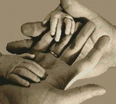 the hands of two adults holding a baby