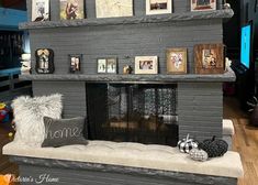 a living room with a fireplace and pictures on the mantle