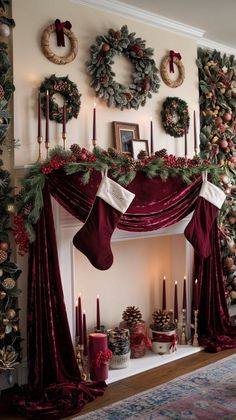 a fireplace decorated for christmas with wreaths and candles