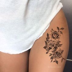 a woman's thigh with roses tattoo on it