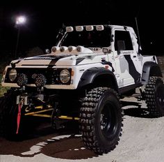 an off - road vehicle is parked in the dark