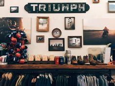 there are many items on the shelf in this room that is filled with memorabilia and photos