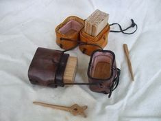 an old pair of shoes and brush on a white sheet with other items in the background