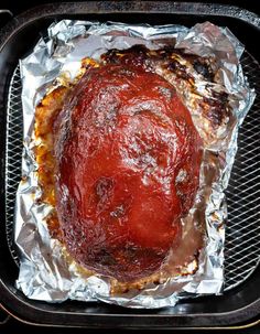 the meat is covered in tin foil and ready to be cooked on the bbq