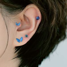 a woman's ear with blue butterflies on it