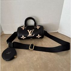 This Louis Vuitton Empreinte Monogram Papillon Bb In Black & Beige Is A Chic Crossbody Bag Perfect For Women On-The-Go. The Bag Features A Zip Closure And Leather Handles With A Drop Of 2.75 Inches. The Bag Is Made Of Leather And Has A Width Of 8 Inches, A Height Of 4 Inches, And A Depth Of 4 Inches. The Bag Also Features Gold Hardware, A Black Lining, And A Monogram Pattern. The Louis Vuitton Nylon Strap Drop Is Adjustable, Ranging From 13 To 21 Inches. The Model Is Named Louis Papillon And Is Mini Duffle Bag, Chic Crossbody Bag, Louis Vuitton Empreinte, Monogram Pattern, Leather Handles, Beige Color, Black Cream, Leather Handle, Louis Vuitton Bag