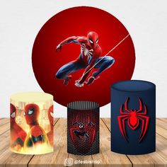 three spider - man mugs are on a wooden table with a red ball in the background