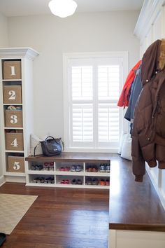 the closet is organized with shoes, coats, and other things to keep in place