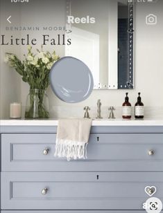 a bathroom vanity with blue drawers and a mirror above it that says,'little falls '