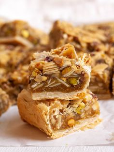 several pieces of fruit and nut bars stacked on top of each other, ready to be eaten