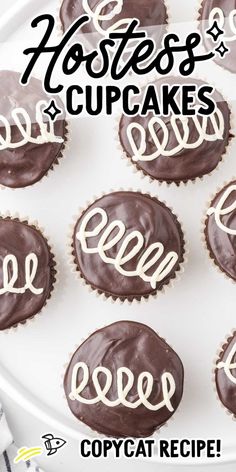 chocolate cupcakes with white frosting and the word love spelled in cursive