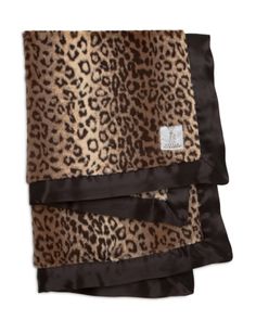 a leopard print blanket with black satin trims and an animal print design on it