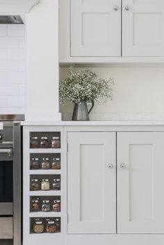 a kitchen with white cupboards and an oven in the back ground, filled with food